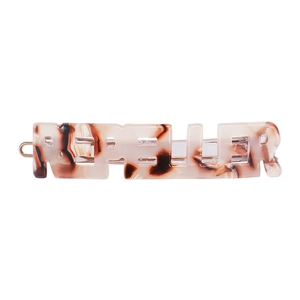 Detailed macro view of the tortoise shell pattern and metal spring clip on acetate hair pin