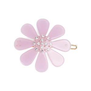 Detailed view of the purple flower hair clip with sparkling crystals on a gold metal base