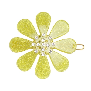 Detail of yellow glitter flower hair clip with sparkling rhinestones and gold metal base