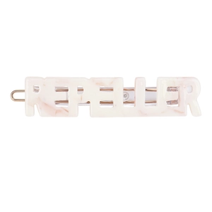 Detail view of pink marble acetate hair clip with REPELLER letter design and gold metal fastener
