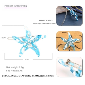 Detail showing blue and white starfish hair clip dimensions of 6cm x 5.6cm with rhinestones