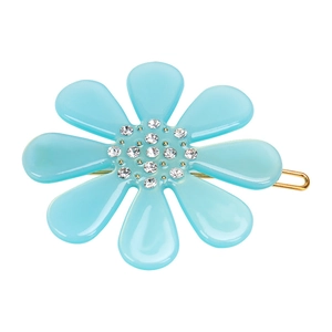 Macro detail of sky blue flower hair clip with sparkling rhinestones and gold-tone base