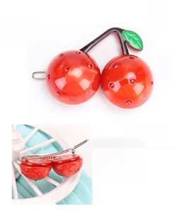Detailed view of red cherry hair clip crafted from high-quality acetate with rhinestones