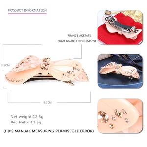 Detail view of acetate bow hair clip with rhinestones and size specifications