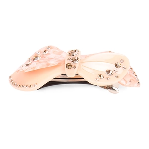 Detail of light pink acetate bow hair clip with sparkling rhinestones and metal spring