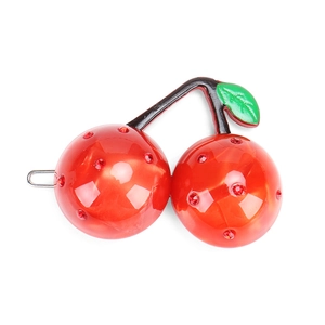 Detail view of cherry hair clip featuring red crystals and green leaves on silver metal