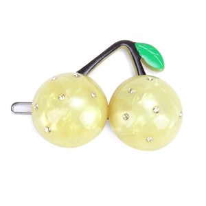 Detailed macro of cherry-shaped hair clip with yellow resin beads and sparkling rhinestones
