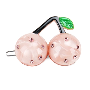 Detailed close-up of a pink marble resin cherry hair clip with sparkling crystals