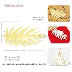 Macro view of lemon yellow acetate leaf hair clip with fine glitter and gold metal clip