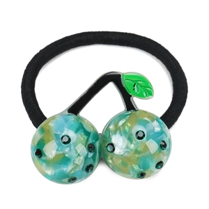 Close-up of marble pattern cherry hair tie with green rhinestones and black elastic