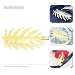 Detail view of a sparkling yellow leaf hair clip with resin glitter and a rhinestone