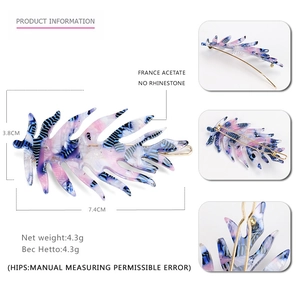Leaf-shaped acetate hair clip with blue and purple tortoiseshell texture measuring 7.4cm
