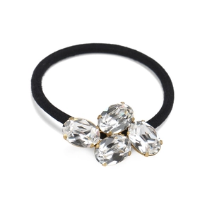 Detail of elastic hair tie featuring oval crystal rhinestones in gold metal claws