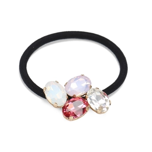 Detailed close-up of oval multi-color crystal rhinestones on a black elastic hair tie