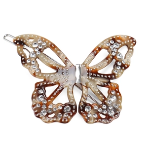 Vue détaillée de la pince papillon en acétate avec motif écaille et strass brillants