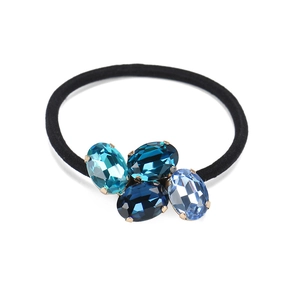 Elegant elastic hair tie featuring four oval blue crystals with secure metal claw settings