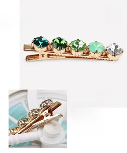 Detail showing high-quality gradient green crystals on a gold alloy hair clip