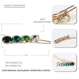 Macro view of gold alloy hair clip with gradient green crystals and size measurements