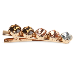 Detailed close-up of golden metal duckbill clip with five gradient brown crystal rhinestones