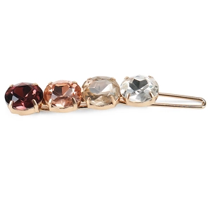 Detail of gradient crystal hair clip with oval stones in wine red and champagne gold finish