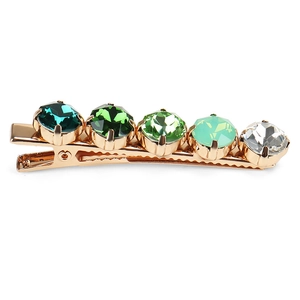 Detail view of gold alloy hair clip with gradient green and white crystal rhinestones