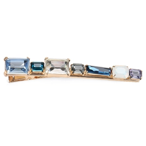 Close-up of golden hair clip with multi-colored rectangular crystals in a row