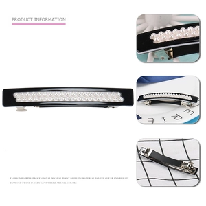 Close-up of geometric acetate spring hair clip with double-row faux pearl inlay detail