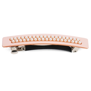 Detail of elegant pink acetate hair clip with double rows of glossy white pearls and metal clasp