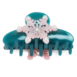 Detailed view of dark green hair claw with pink snowflake, pearls and small rhinestones
