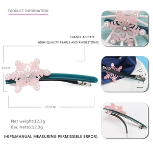 Detail view of snowflake acetate hair clip with pearls and sparkling rhinestones