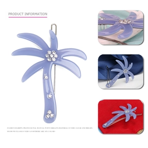 Macro detail of purple acrylic coconut tree hair clip with hand-set sparkling crystals