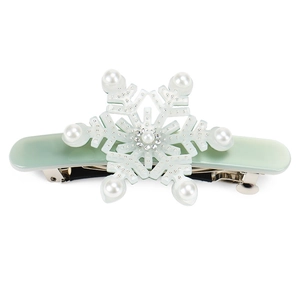 Detail of mint green snowflake hair clip with white pearls and small crystals