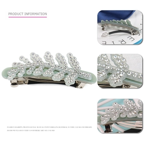 Detail of leaf-shaped hair clip with mint green acetate and sparkling crystal rhinestones