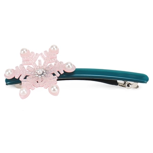 Close-up of snowflake hair clip with pearls and rhinestones on high-quality acetate base