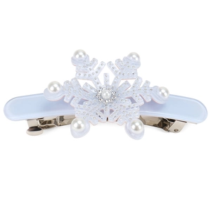 Detailed view of a light blue snowflake hair clip with pearls and sparkling rhinestones
