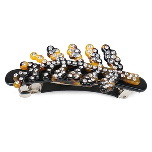 Detail of vintage tortoise shell hair clip with leaf shape rhinestones and spring clip
