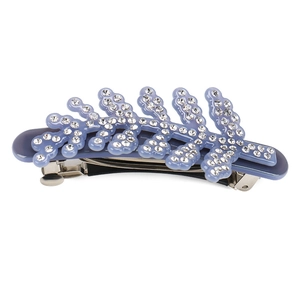 Detailed view of the sparkling rhinestone leaf hair clip with dark blue acetate finish