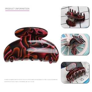 Elegant marble pattern acetate hair claw clip in deep red and black amber texture