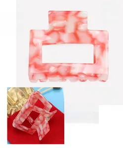 Detail of a marble textured acetate hair claw clip measuring 4.5 by 5cm for hair styling