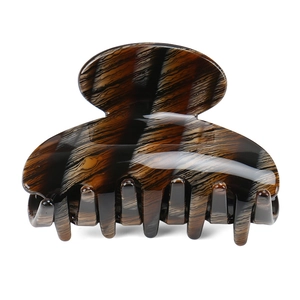 Detailed macro view of the tortoiseshell patterned cellulose acetate hair claw clip