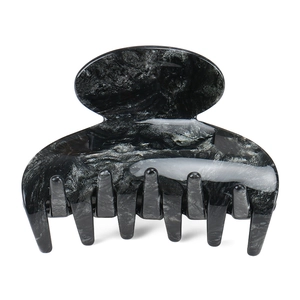 Detail of medium acetate hair claw clip featuring elegant black and white marble patterns