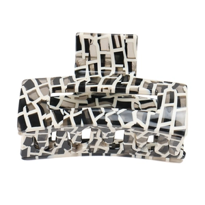 Minimalist geometric hollow hair claw clip with black white and grey checkerboard pattern