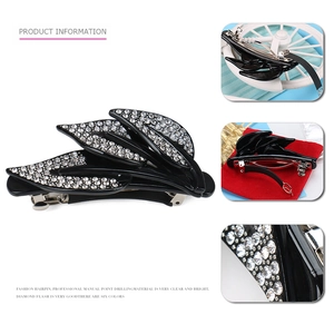 Detail view of vintage leaf spring hair clip with white rhinestones and metal fastener
