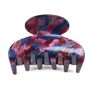 Detail view of medium acetate hair claw clip with colorful mosaic texture and metal spring