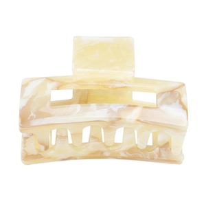Detailed macro view of acetate hair claw clip showing elegant beige marble texture