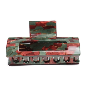 Detail view of large rectangular acetate hair claw with vintage red and green marble pattern