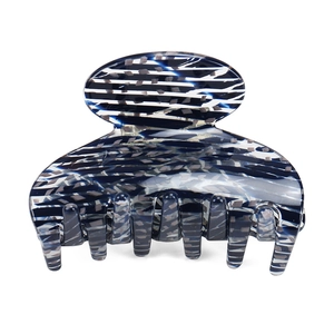 Detailed macro view of the marble blue acetic acid hair claw with multiple gripping teeth