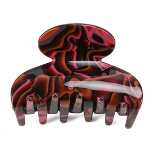 Macro view of marble patterned tortoise shell hair claw clip with glossy acetate finish