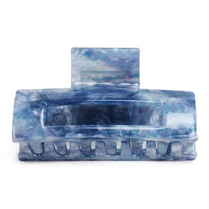 Detail of large acetate hair claw clip featuring blue and purple marble texture