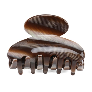 Detail of coffee marble pattern cellulose acetate hair claw clip with glossy finish